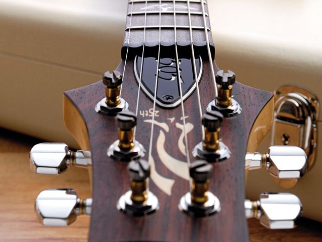 PRS 25th Anniversary 305 The rosewood-faced peghead has the 25th anniversary logo for this year only.