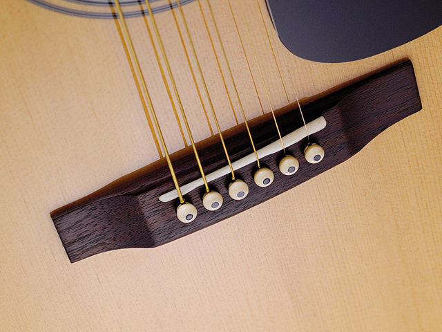 Note the intonation-compensated saddle. And it's bone too - superb at this price.