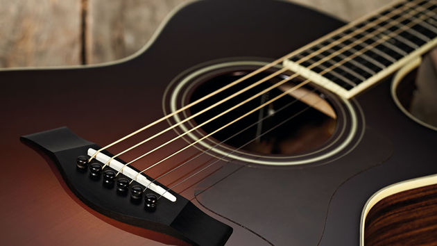 Taylor 712ce (soundhole) There's a very dark brown, gloss-finished top with a brighter orange 'sun' in the centre