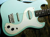 Masonite/plywood body; bolt-on maple neck; rosewood fingerboard; 19 frets; 25" scale; 2 x lipstick singlecoils; volume, tone and 3-way pickup selector; satin chrome hardware; aqua, black, burgundy, gold, keen green, peach, red burst or tangerine finish