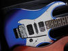 Solid wood body; bolt-on maple neck; rosewood fingerboardm, dot inlays; 25.5" scale; 2 x Wilkinson doublecoils, Wilkinson single-coil; volume, tone, 5-way pickup selector; Floyd Rose double-locking tremolo, Wilkinson WJ07 tuners; electric metallic blue finish