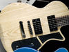 Solid ash body; bolt-on maple neck; rosewood fingerboard; 24 frets; 25.5" scale; 2 x high output humbuckers; volume, tone, 3-way pickup selector; nickel hardware; natural or scar red finish