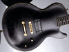 Mahogany body with quilted maple top; set mahogany 3-ply neck; artificial ebony fingerboard with dot inlays; 24.75" scale; Seymour Duncan JB humbucker; volume, tone, 3-way pickup selector; gold hardware; dark red finish