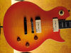 Mahogany body with carved flame maple top; set mahogany neck; rosewood fingerboard with crown inlays; 24.75" scale; 2 x Wilkinson P-90 stacked humbuckers; master volume, master tone, 'roll control', 3-way pickup selector; nickel hardware; Flame Honeyburst or Gold Top finish