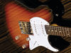 Chambered alder body; bolt-on maple/bubinga neck; rosewood fingerboard with dot inlays; 25.5" scale; 3 x Wilkinson single-coils (stacked at bridge); volume, tone, roll control, pickup selector; nickel hardware; sunset sunburst finish