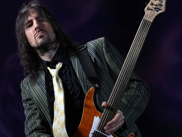 Wait a minute, that guitar hasn't got any frets!