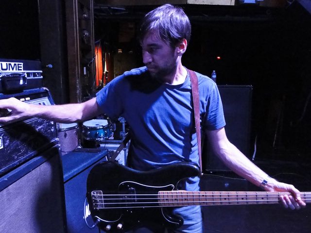 Bassist Eric Larson makes a last-minute tweak before soundcheck