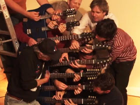 VIDEO: Eight men play Crossroads on an 8-necked guitar