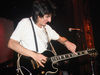 Ronnie Wood using a harmonica as a makeshift slide