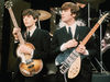 McCartney and Lennon, with two of the instruments they would be associated with
