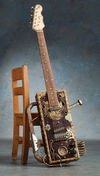 Made from a First Act Strat-copy neck and two Tabak cigar boxes