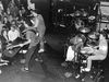 Mike Watt, D. Boon, and George Hurley performing on stage as The Minutemen