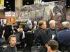 A scary backdrop... As minglers mingle, Bill Reim (second from right), president of Hoshino USA, holds forth
